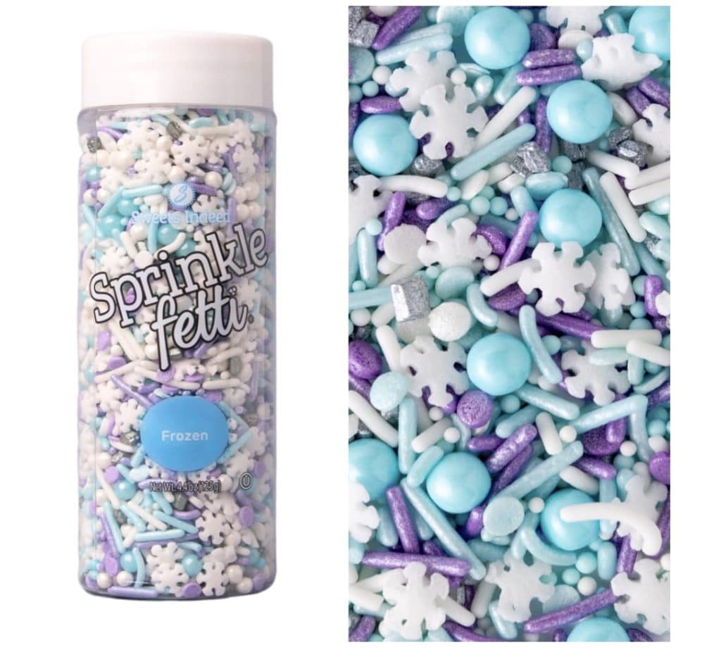 A bottle labeled "Sprinklefetti Frozen" sits beside a close-up of its contents, ideal for crafting enchanting Snow Globe Cookies. It contains blue, purple, white, and silver sprinkles in various shapes like snowflakes, balls, and rods.